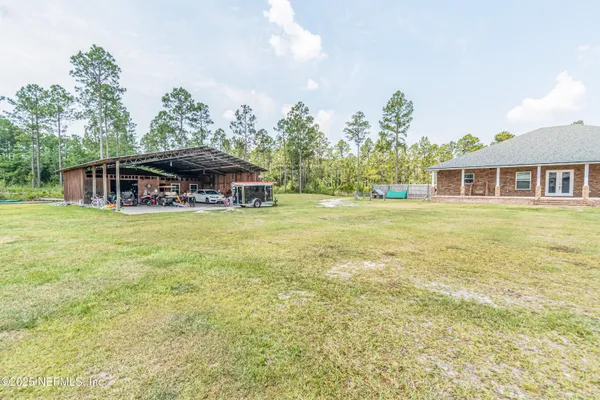 a bedroom with a bed dresser and flat screen tv