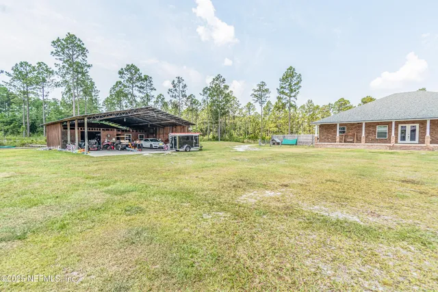 a bedroom with a bed dresser and flat screen tv