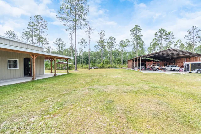 a kitchen with a sink wooden floor and white cabinets