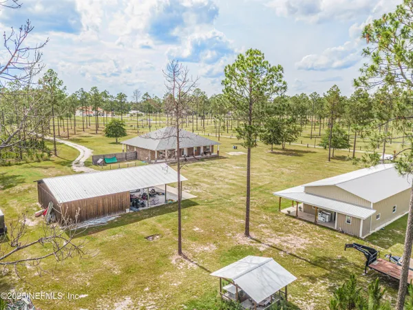 a view of a swimming pool with a yard and trees