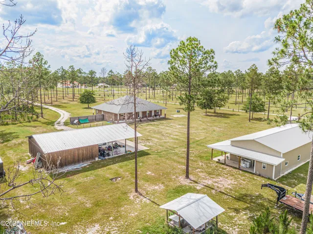 a view of a swimming pool with a yard and trees