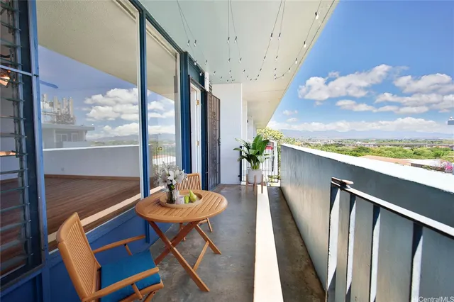 a dining room with furniture and a floor to ceiling window