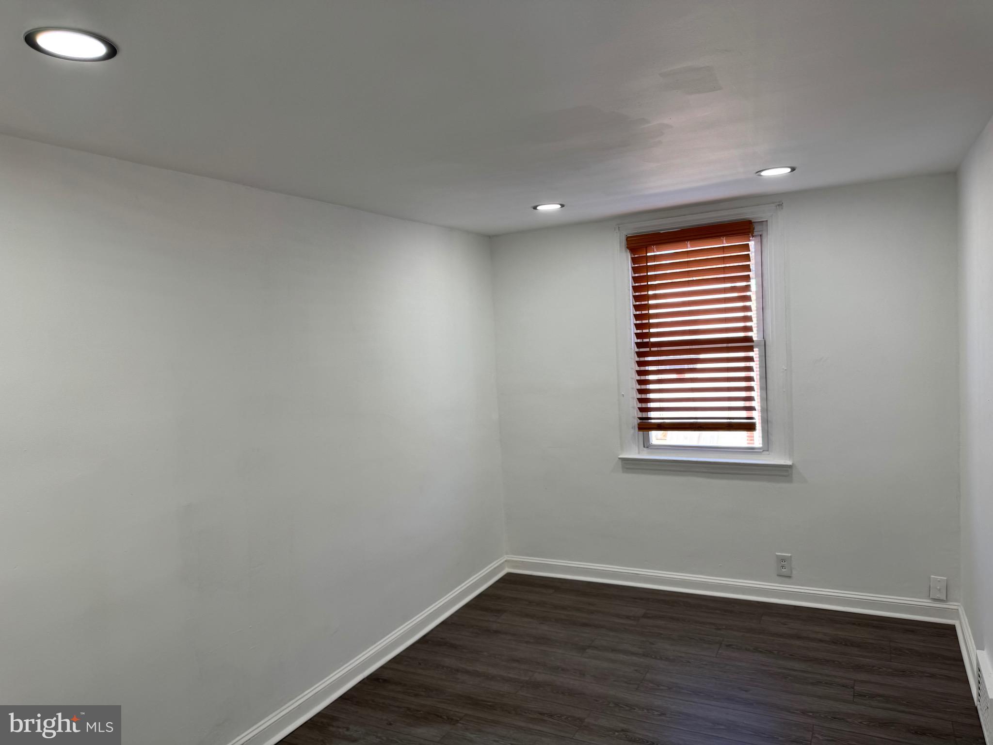 1203 Edgehill Road Darby, PA 19023 - Photo 11 of 24 a view of an empty room with wooden floor and a window
