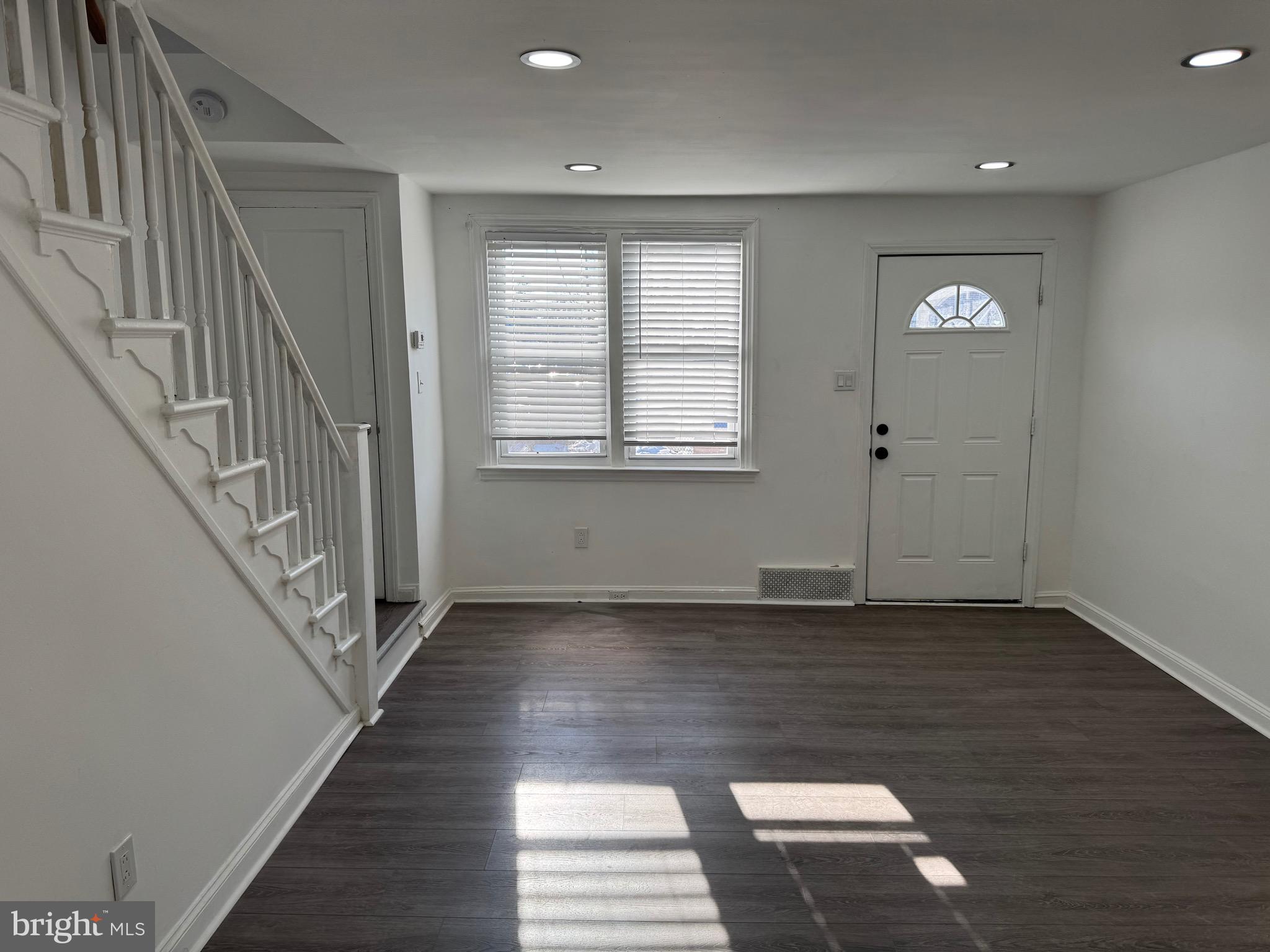 1203 Edgehill Road Darby, PA 19023 - Photo 16 of 24 an empty room with wooden floor and windows