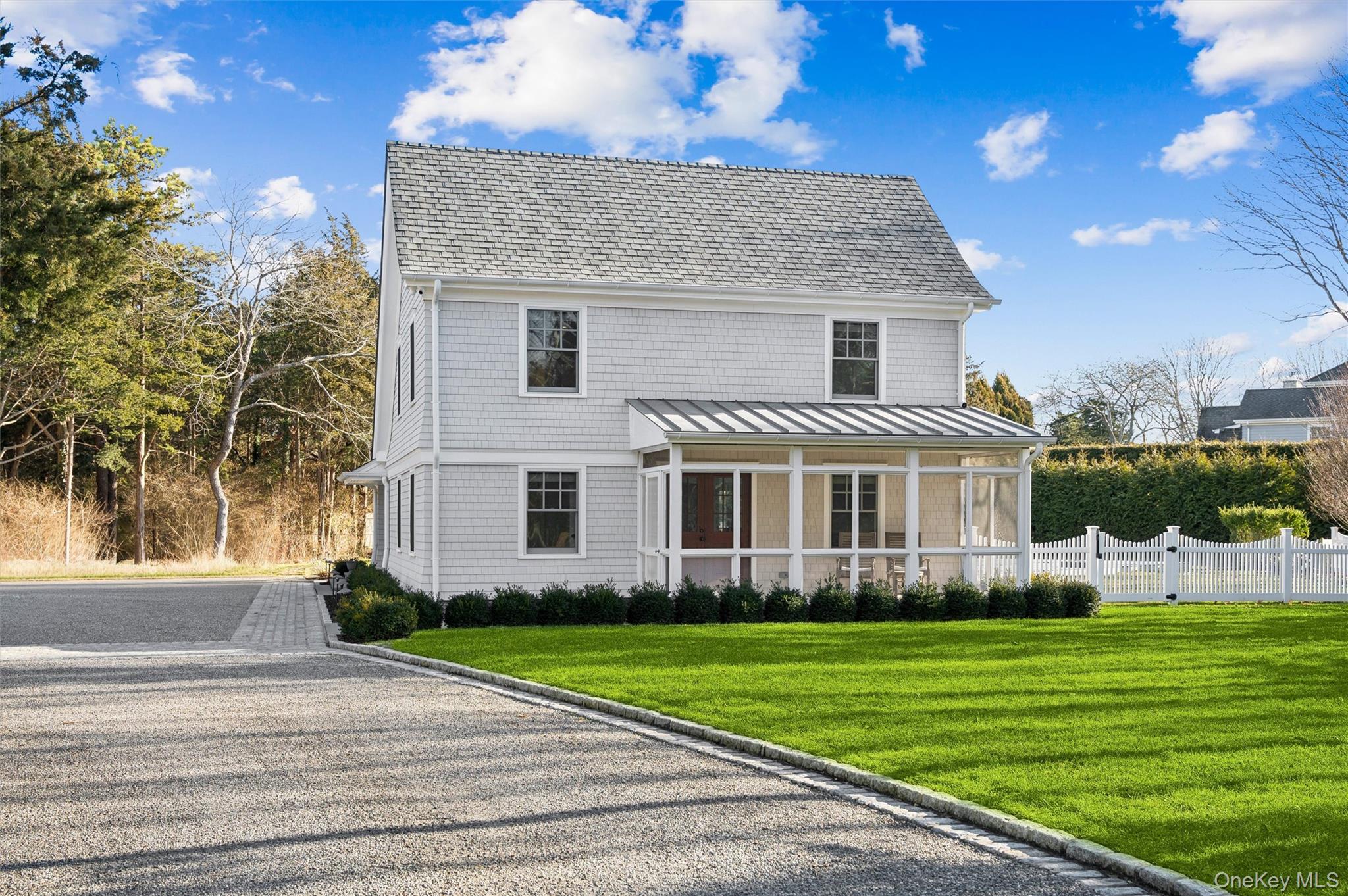 a front view of a house with a garden and yard