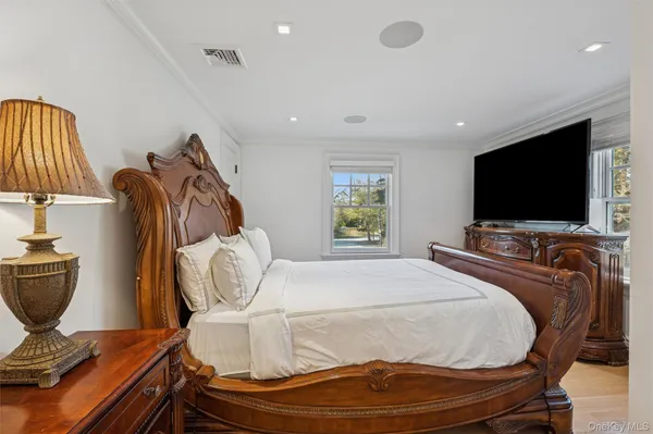 a room with a bed and flat screen tv