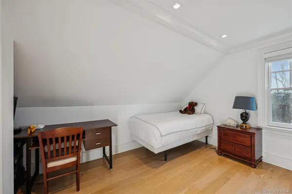a bedroom with a bed and a table in it