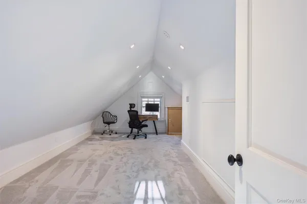 a view of a hallway with wooden floor and furniture