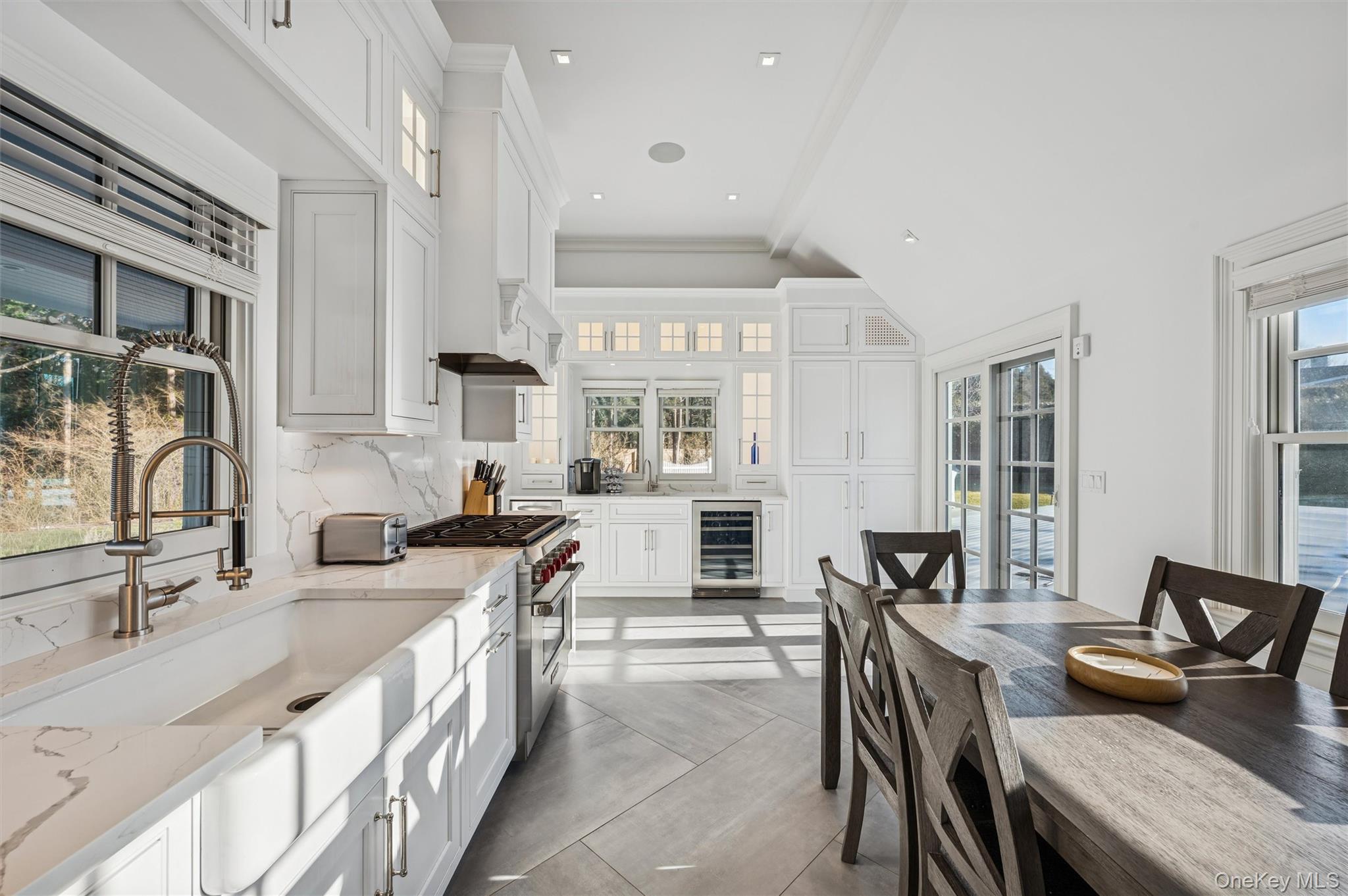 30 Club Lane Remsenburg, NY 11960 - Photo 3 of 19 an open kitchen with granite countertop a sink and white cabinets
