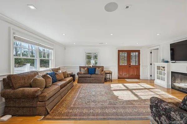 a living room with furniture a flat screen tv and a fireplace