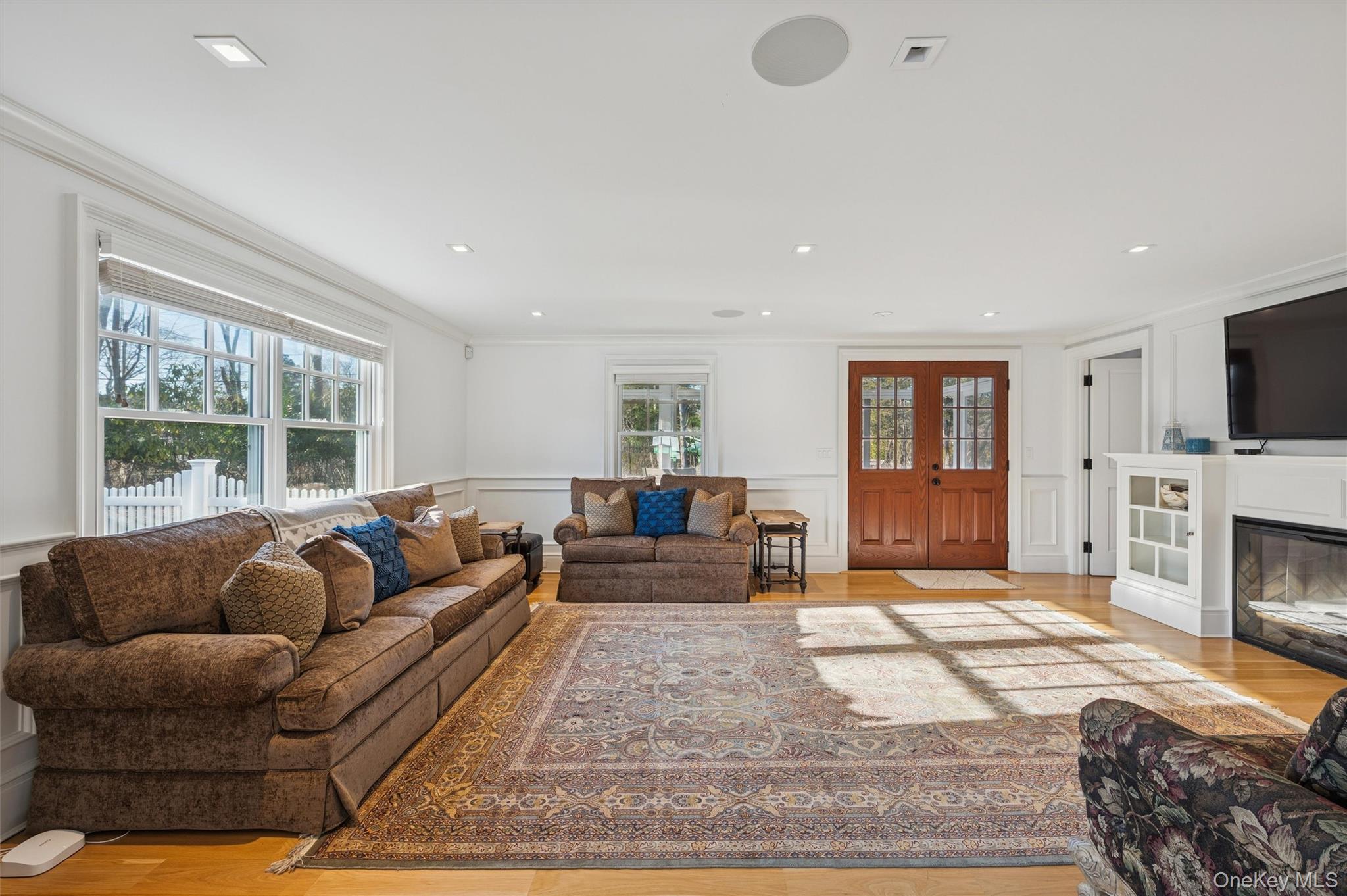 30 Club Lane Remsenburg, NY 11960 - Photo 8 of 19 a living room with furniture a flat screen tv and a fireplace