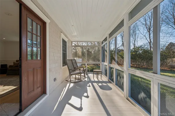a view of a living room and balcony with furniture