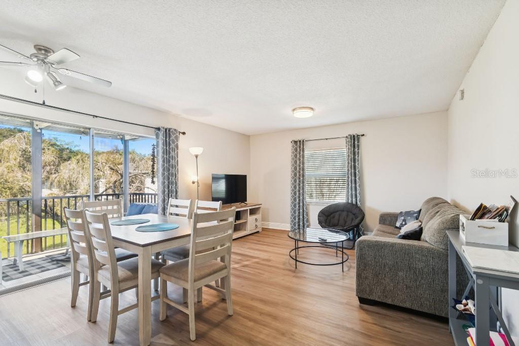 13125 Wilcox Road, Unit 6205 Largo, FL 33774 - Photo 5 of 48 a living room with furniture floor to ceiling window and wooden floor