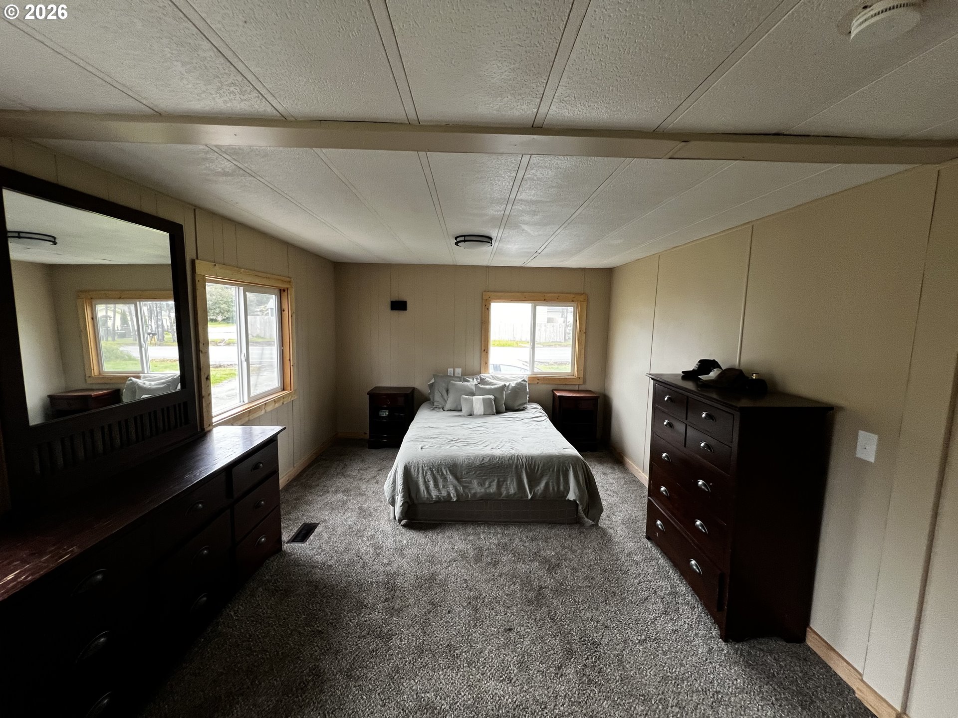 355 North 8th Street Lakeside, OR 97449 - Photo 18 of 22 a spacious bedroom with a bed and window