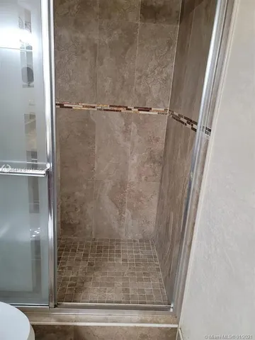 a bathroom with a glass shower door
