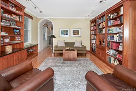 a living room with furniture cabinets and book shelf