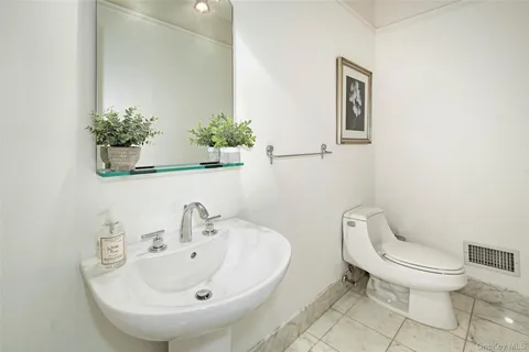 a white toilet sitting next to a bathroom sink