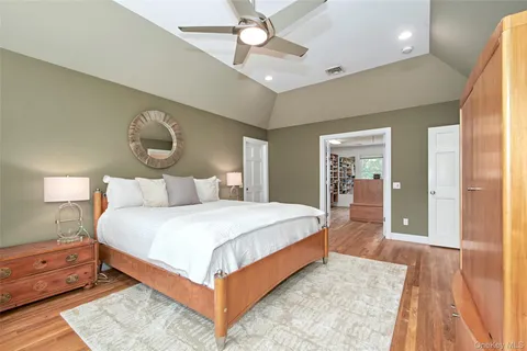 a bedroom with a large bed and a chandelier