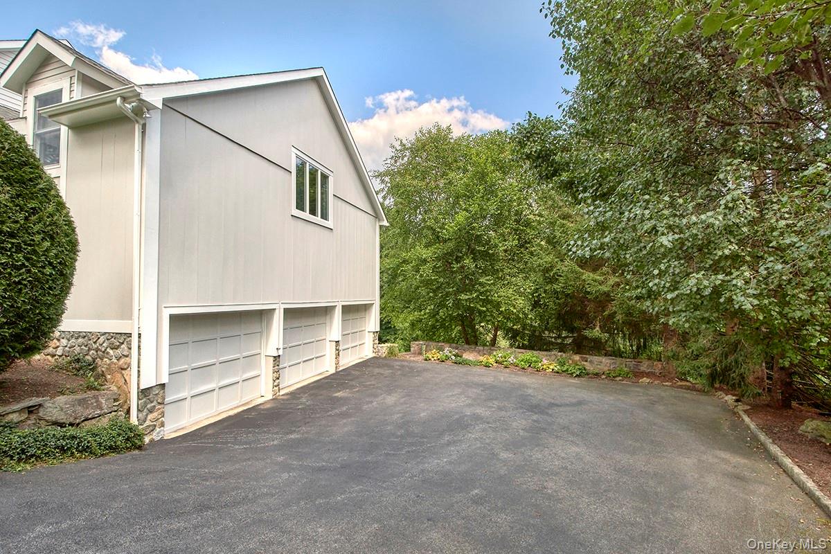 17 Byram Meadows Road Armonk, NY 10504 - Photo 45 of 49 a view of a house with a yard and garage