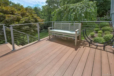a view of a roof deck with wooden floor and fence