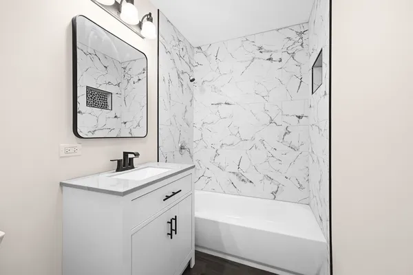 a bathroom with a sink a bathtub and a bathroom