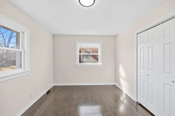 a view of a room with wooden floor and window