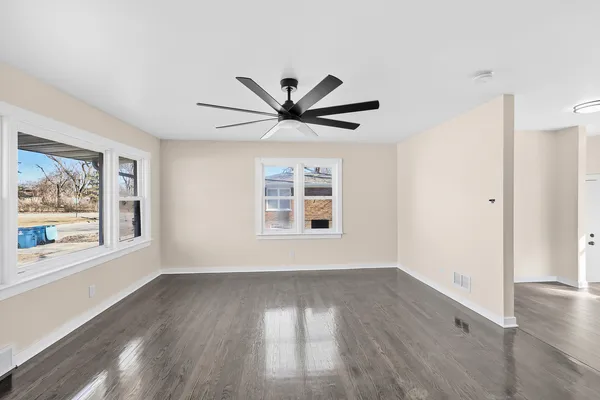 wooden floor in an empty room with a window