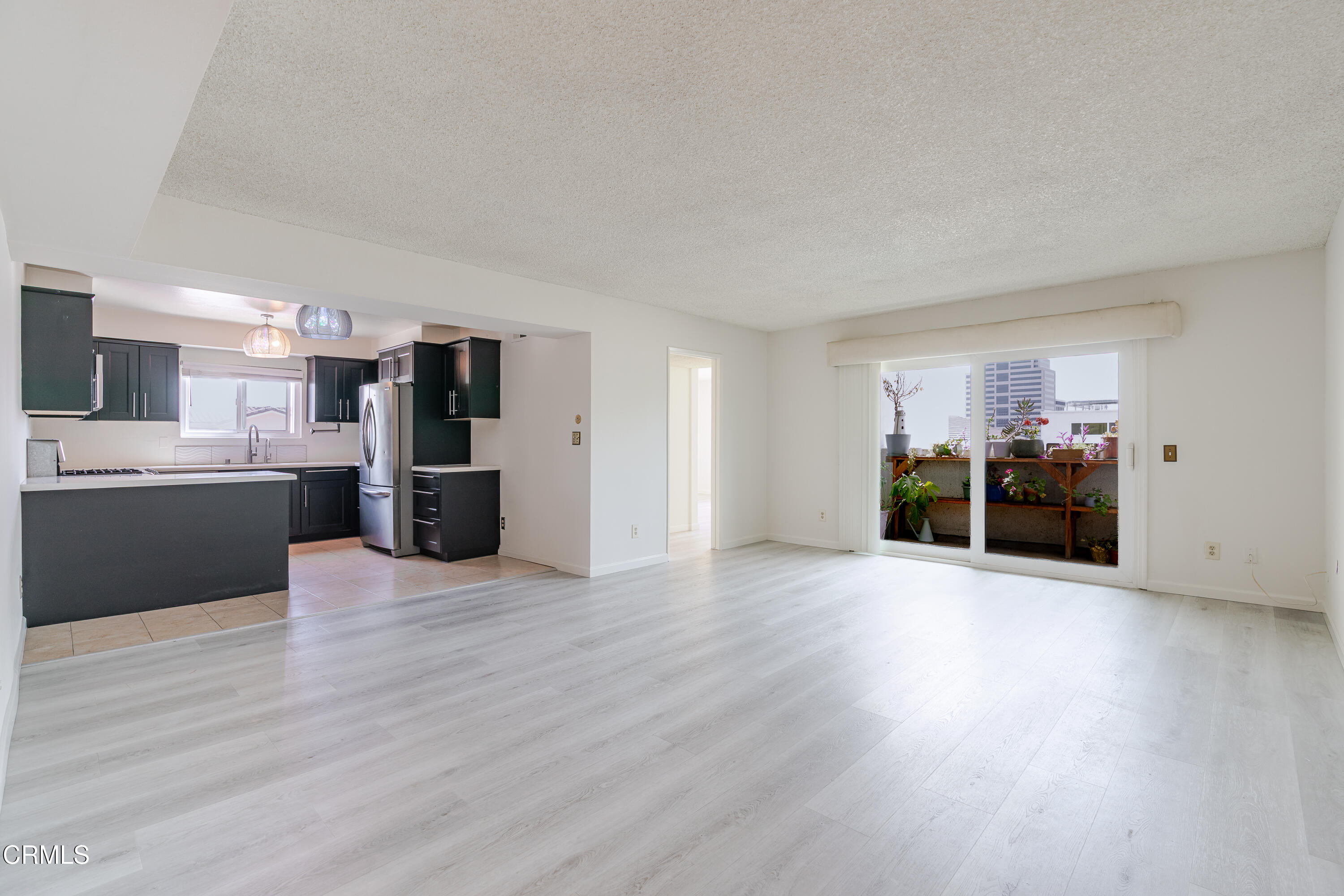a view of a kitchen with a sink and a refrigerator