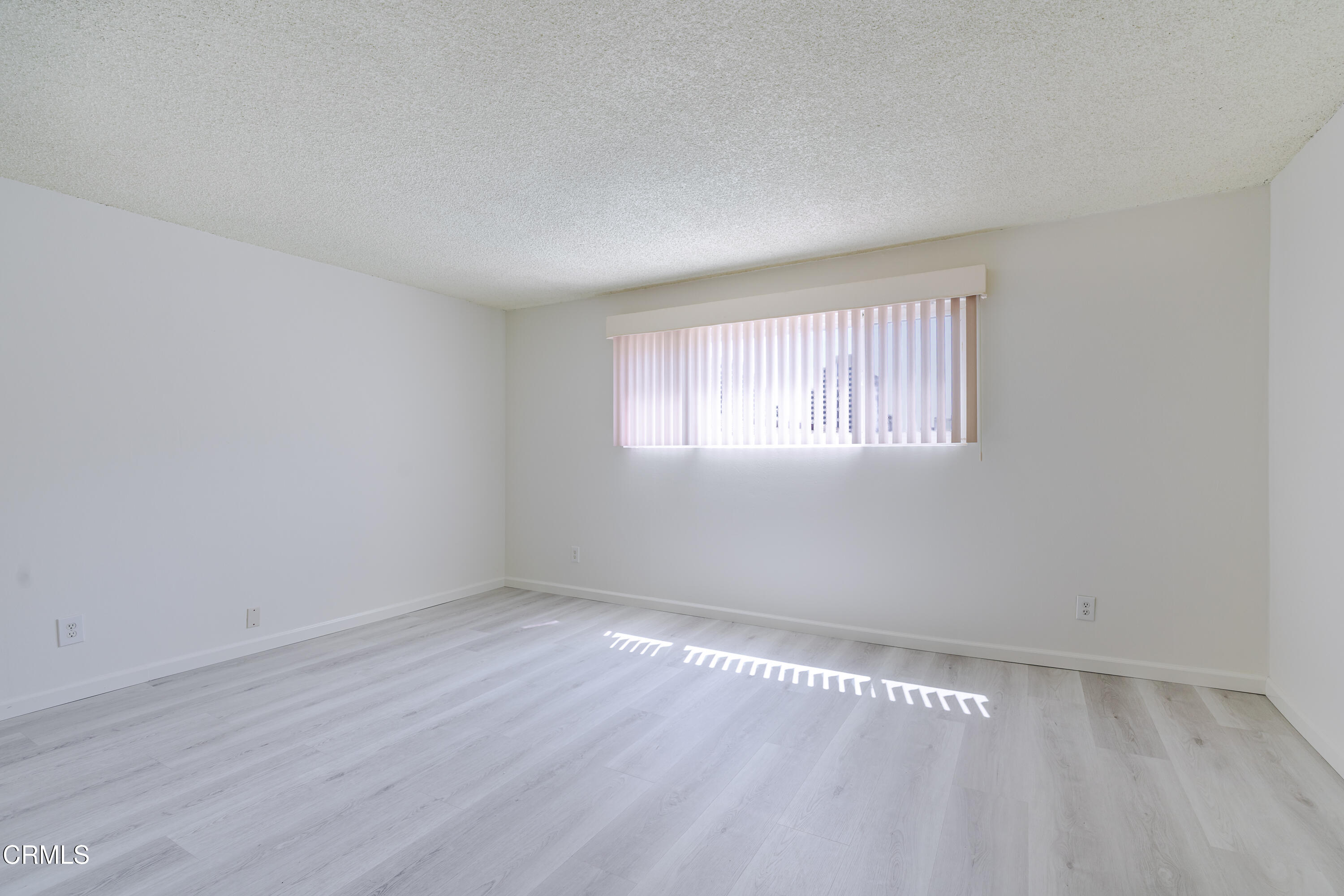 500 Jackson Place, Unit 313 Glendale, CA 91206 - Photo 7 of 19 an empty room with wooden floor and windows