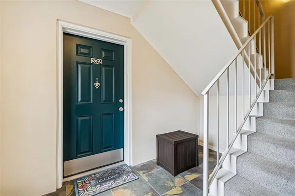 a view of entryway with wooden floor and stairs