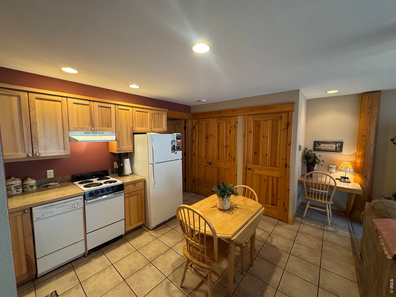 2100 Fall River Road, Unit 4 Estes Park, CO 80517 - Photo 8 of 28 a kitchen with stainless steel appliances granite countertop a refrigerator a sink a stove and island