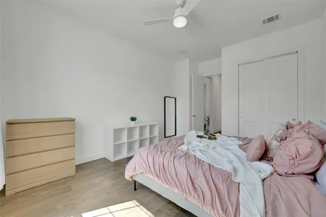 a large bed sitting in a bedroom next to a cabinet