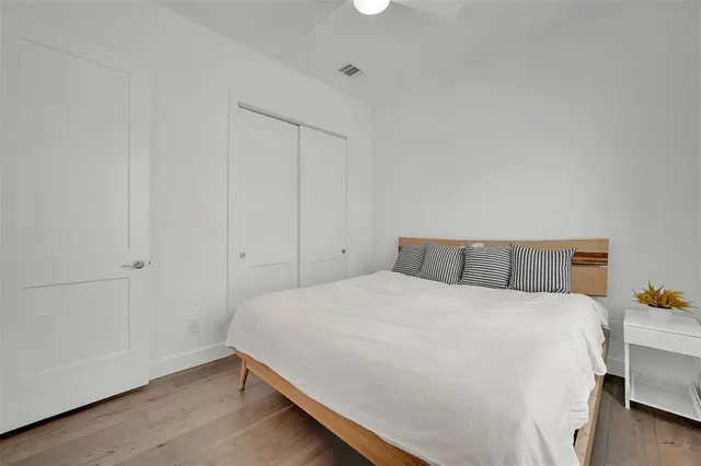 a bedroom with a bed and wooden floor