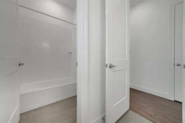 a bathroom with double vanity sinks a vanity a lamp and a mirror