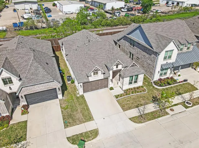 an aerial view of a house with a yard