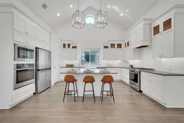 a kitchen with a table chairs stove and cabinets