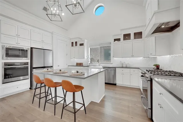 a kitchen with cabinets and window