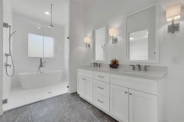 a bathroom with a double vanity sink and a mirror