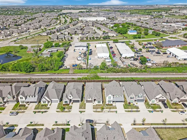 an aerial view of residential houses with outdoor space