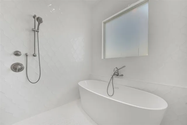 a white bath tub sitting next to a white sink