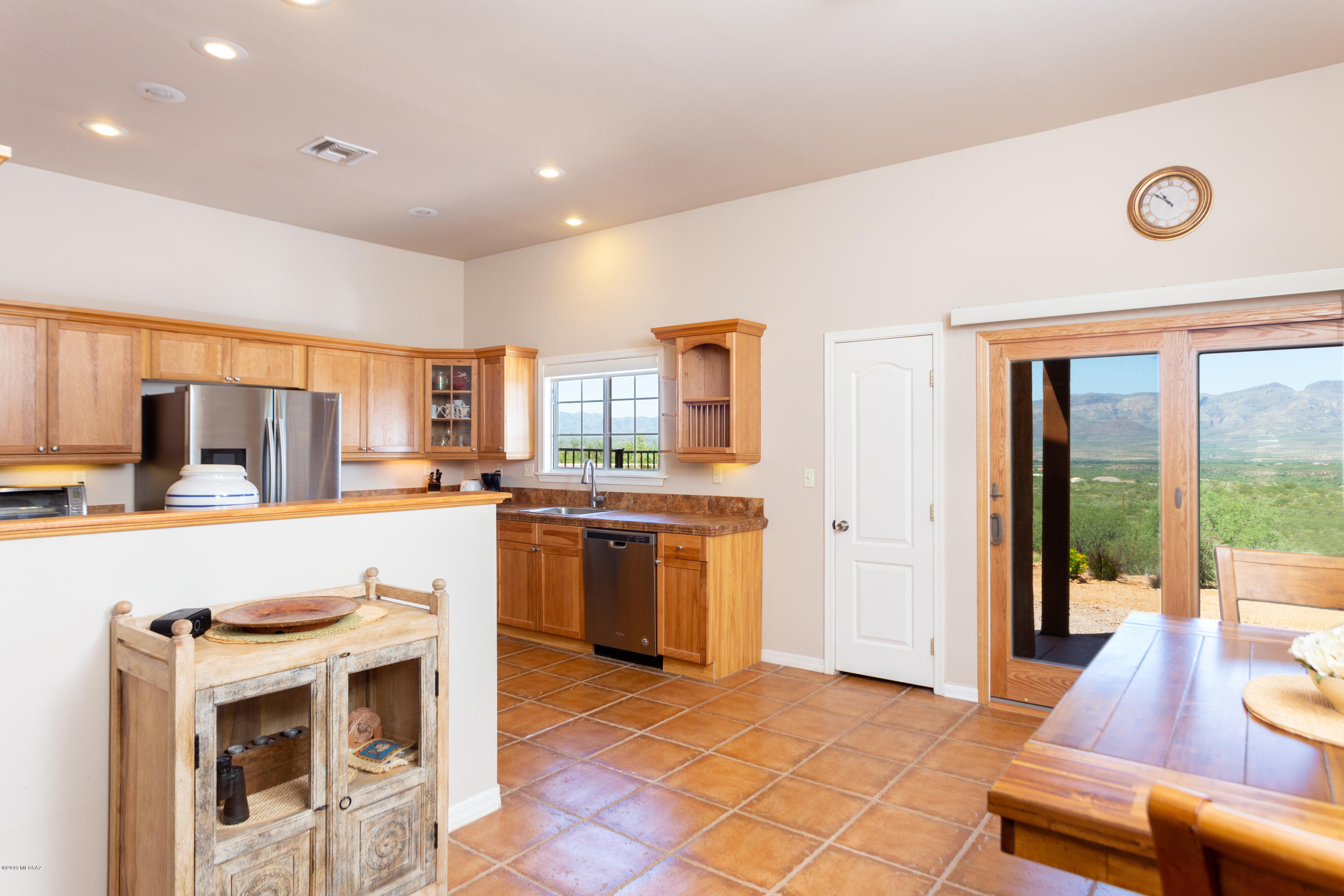 1748 Avenida Pastor Rio Rico, AZ 85648 - Photo 8 of 28 a kitchen with a stove a sink and a refrigerator