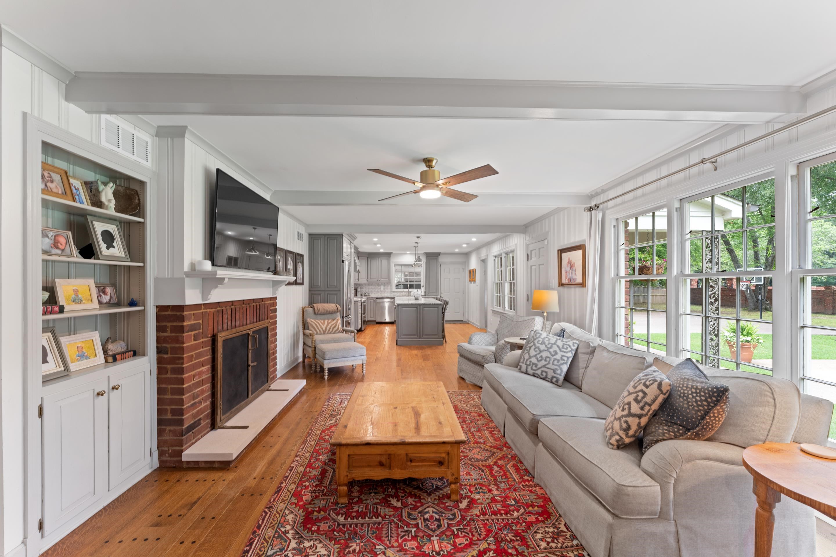 1226 Fair Meadow Road Memphis, TN 38117 - Photo 15 of 40 Great room featuring a brick fireplace, ceiling fan, hardwood flooring, beam ceiling, wet bar and it opens to the kitchen.