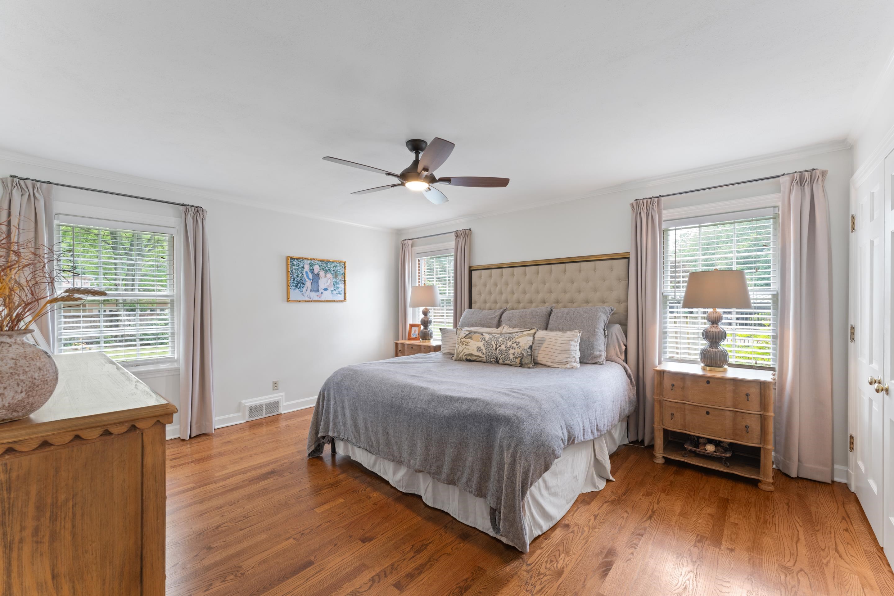 1226 Fair Meadow Road Memphis, TN 38117 - Photo 17 of 40 Primary bedroom with ceiling fan, hardwood flooring, closet, private bathroom and multiple windows.