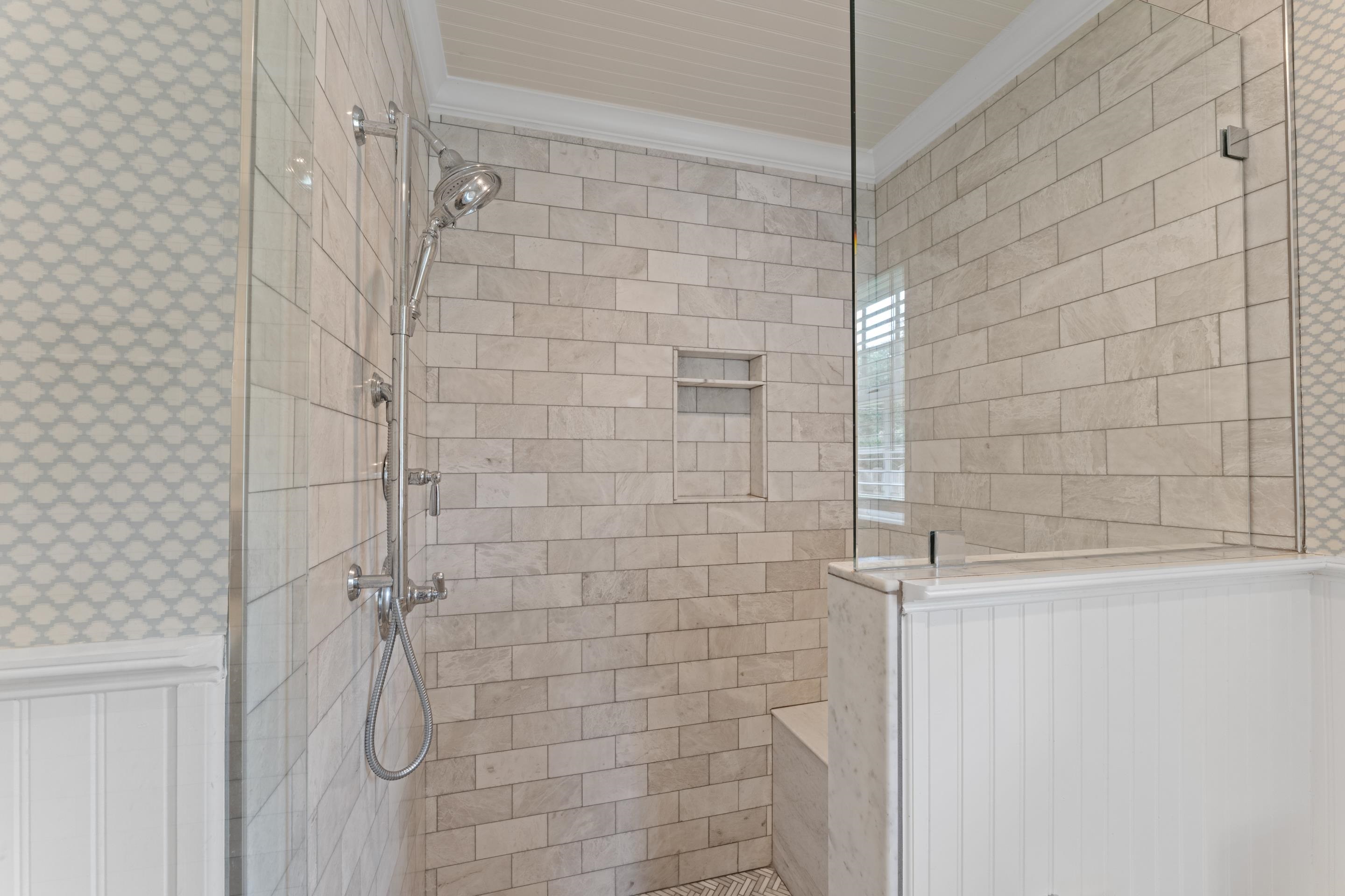 1226 Fair Meadow Road Memphis, TN 38117 - Photo 20 of 40 Large walk-in shower in primary bath featuring a frameless shower door and complete tile surround.
