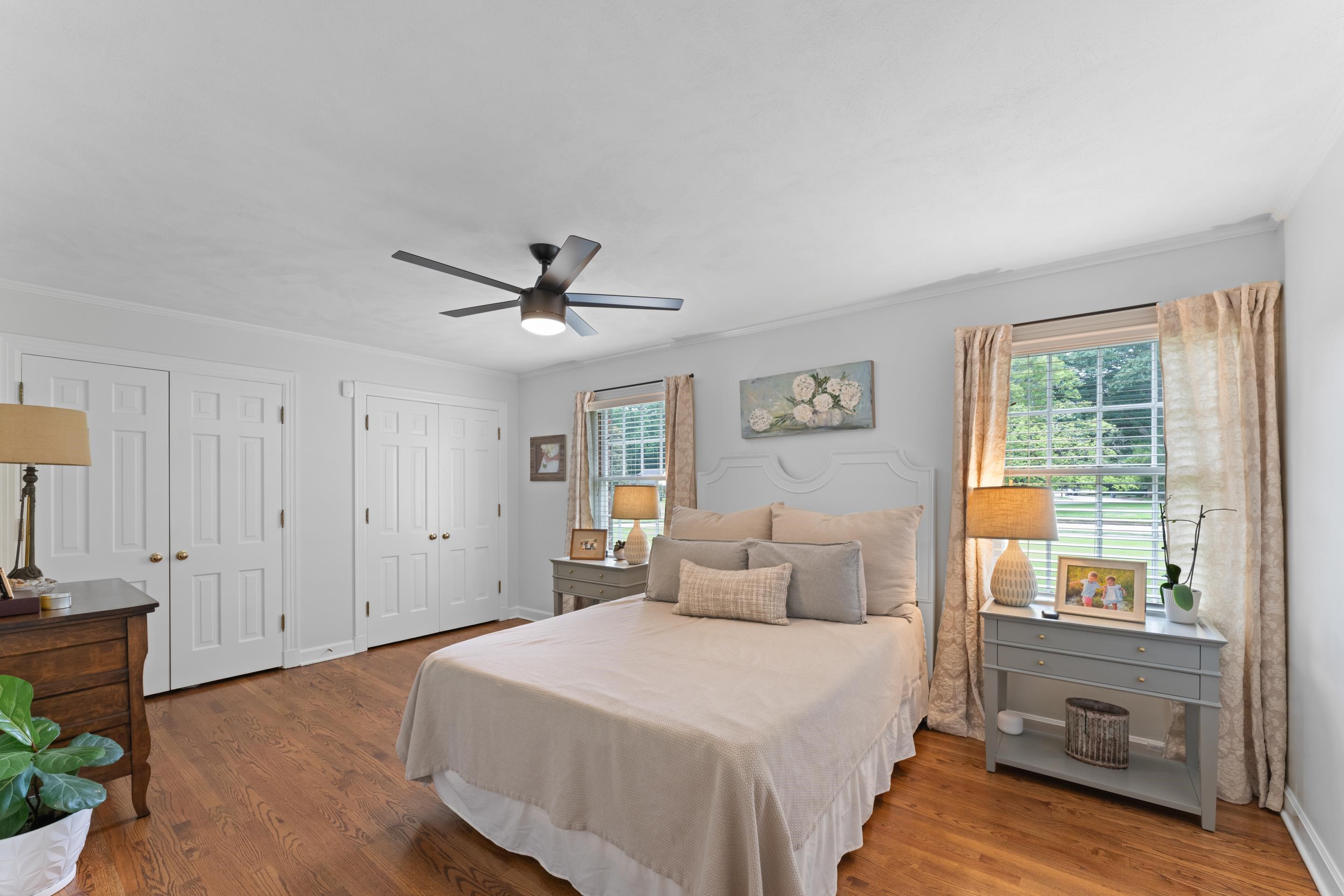 1226 Fair Meadow Road Memphis, TN 38117 - Photo 21 of 40 Bedroom with two closets, ceiling fan, and hardwood floors.