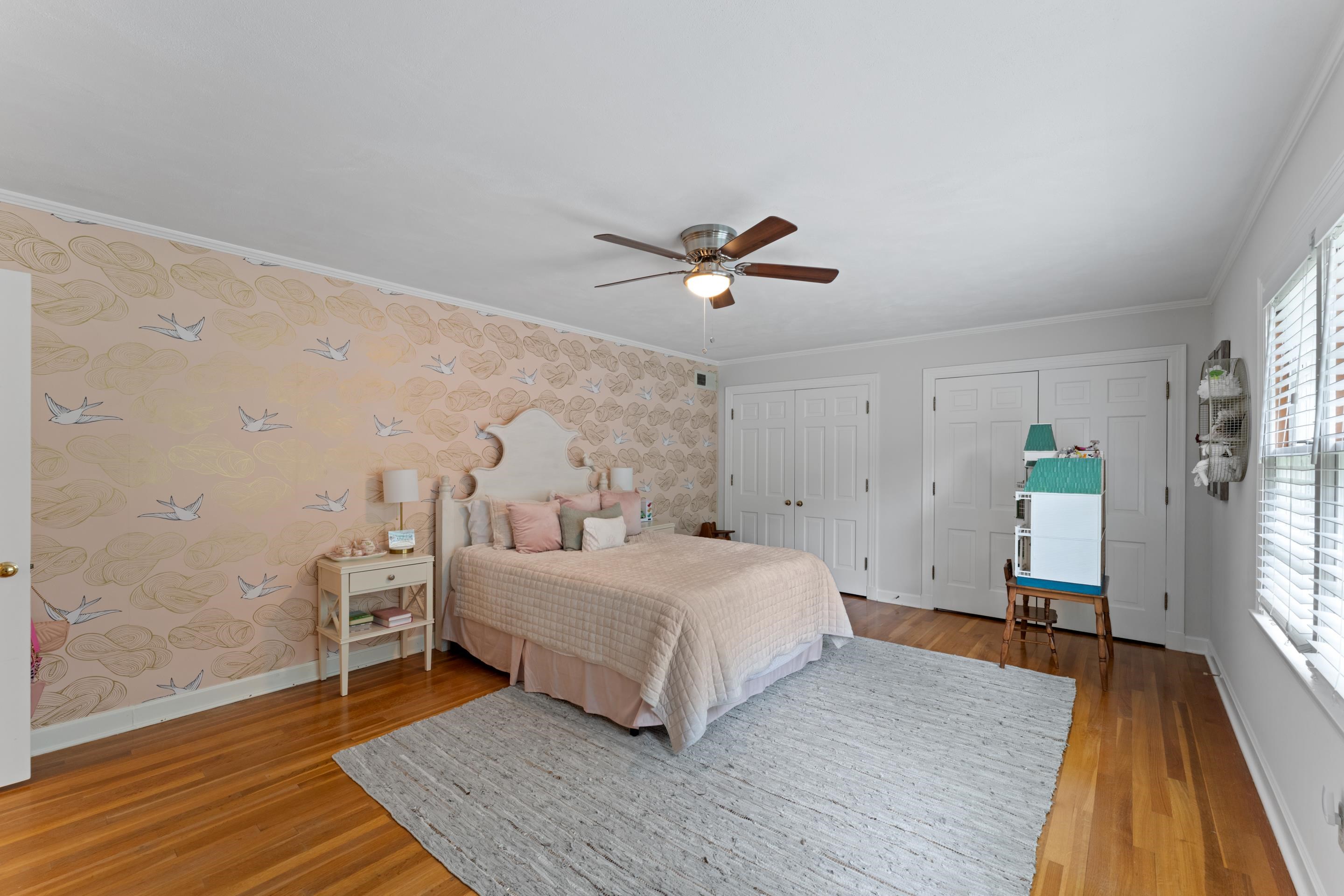 1226 Fair Meadow Road Memphis, TN 38117 - Photo 25 of 40 Bedroom featuring ceiling fan, hardwood flooring, multiple closets, and ornamental molding.