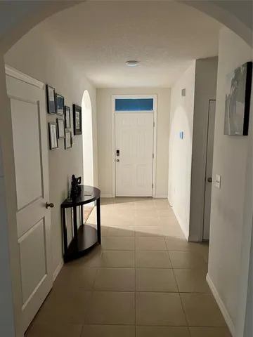 a view of kitchen with furniture and refrigerator