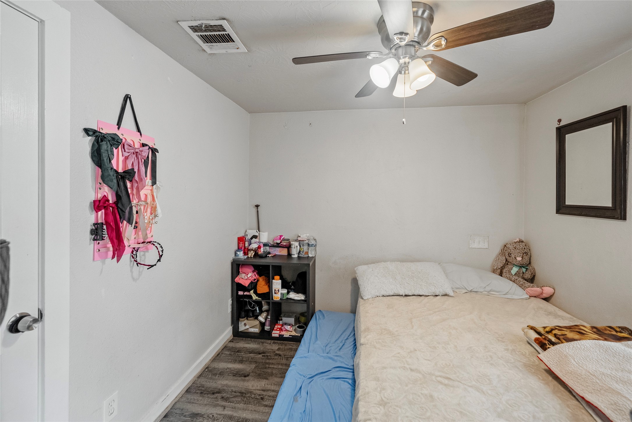 7938 Kerr Street, Unit 6 Houston, TX 77029 - Photo 10 of 18 a bedroom with a bed and a chandelier