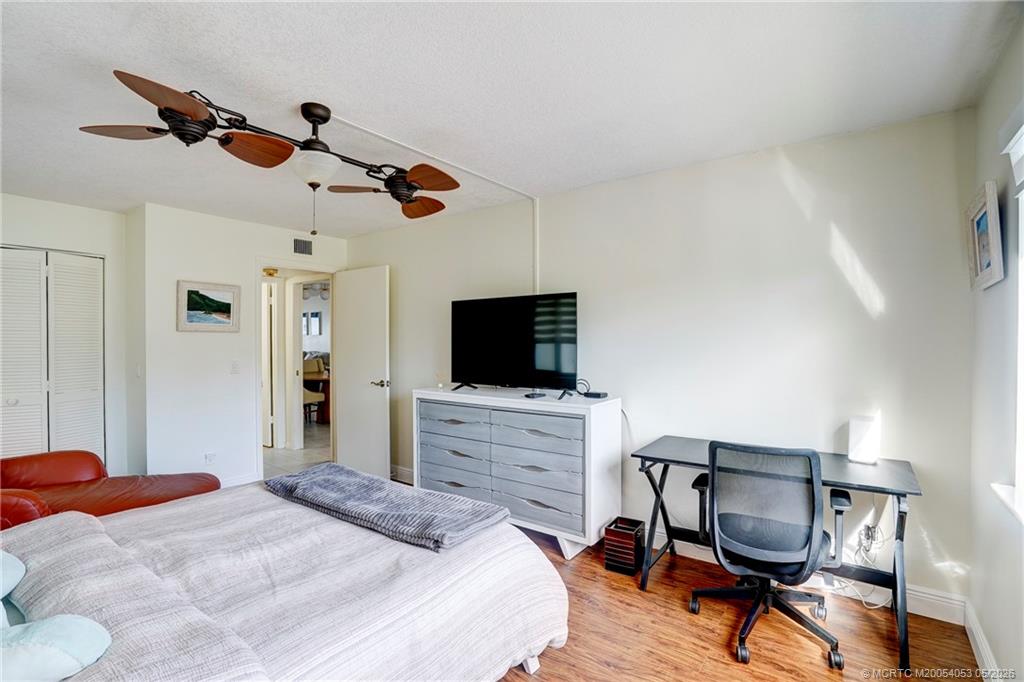 10 Northeast Plantation Road, Unit 101 Jensen Beach, FL 34957 - Photo 43 of 53 a bedroom with a bed and a flat screen tv