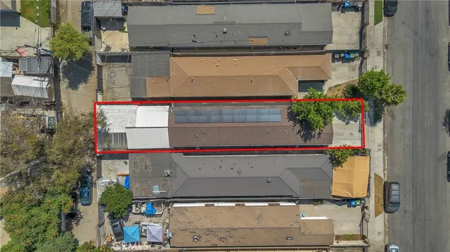 an aerial view of a houses with street